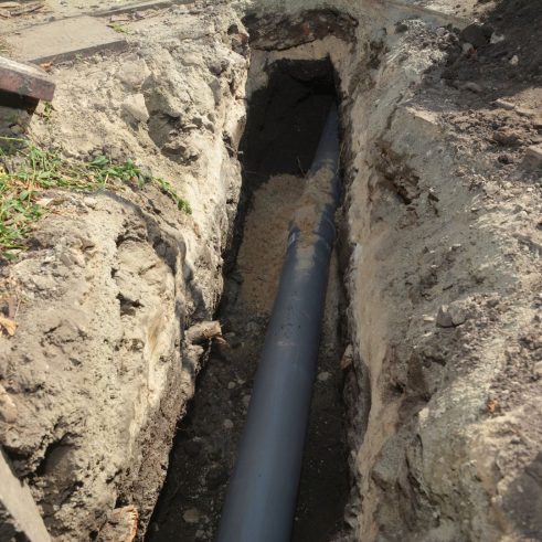 dug up sewer system outside