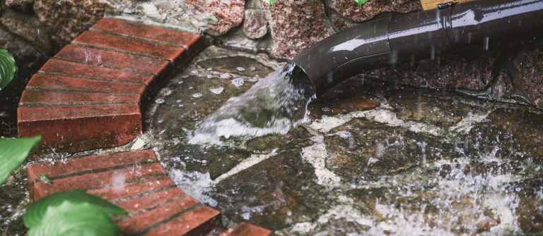 downspout with a lot of water flooding out
